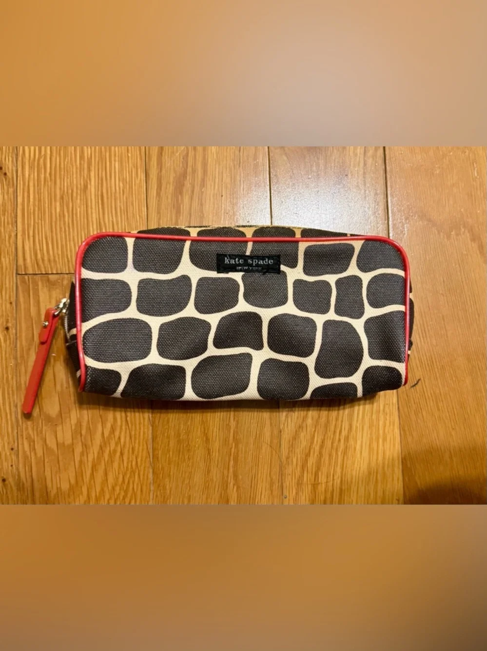 Kate Spade New York cosmetic bag or pencil case featuring a signature giraffe-